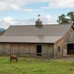 standing seam metal roofing panels on horse barn roof in Albany Oregon